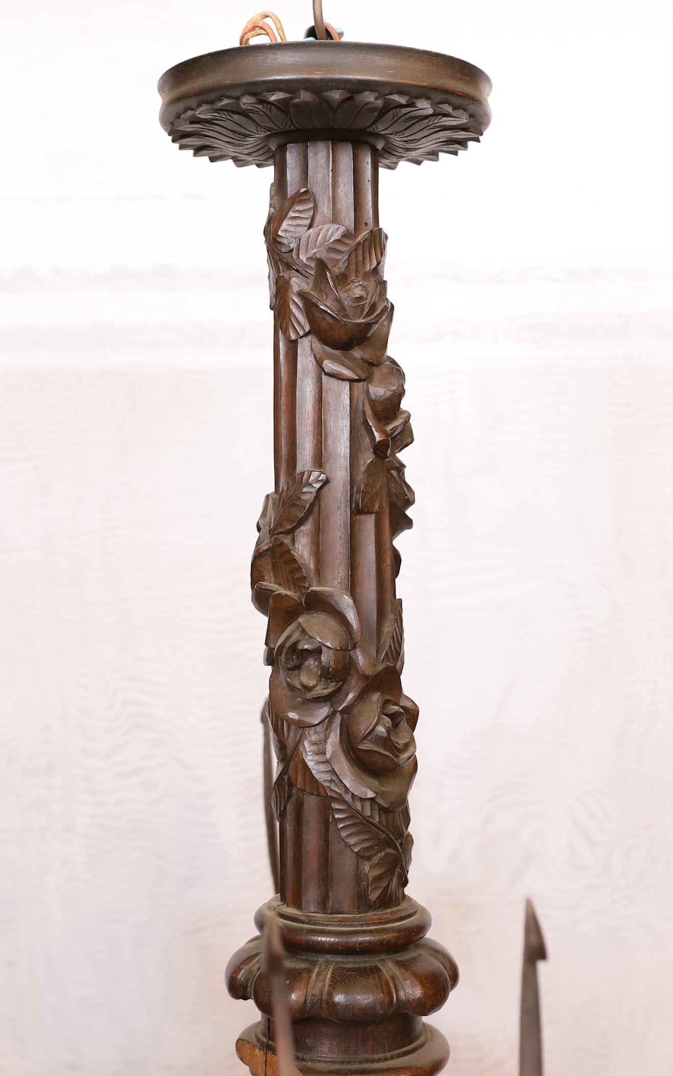 A Swiss Black Forest carved wood four light chandelier with caryatid branches and rose entwined stem, height 92cm. width 92cm